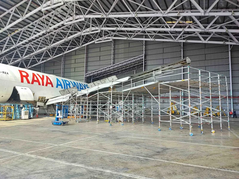 Mega platforms docked along a Raya Airways aircraft in the hangar