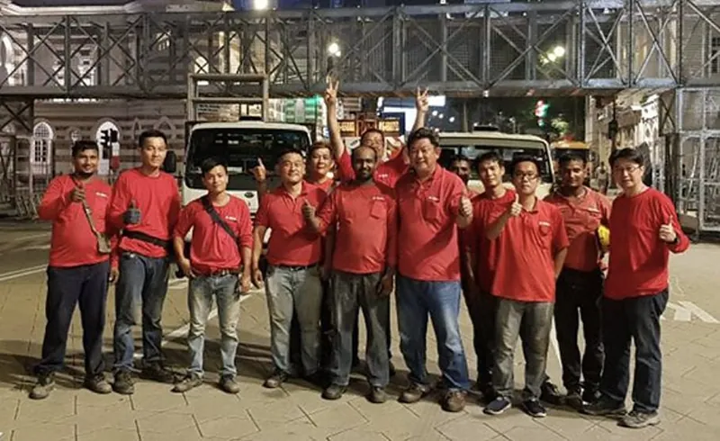 The Mega Access Specialist crew in red company shirts on site at night