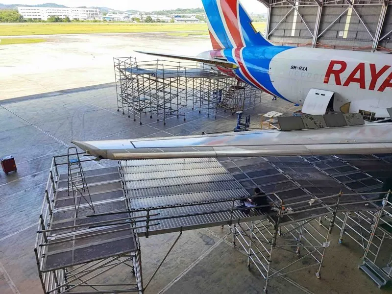 Docking platforms along a Raya Airways aircraft