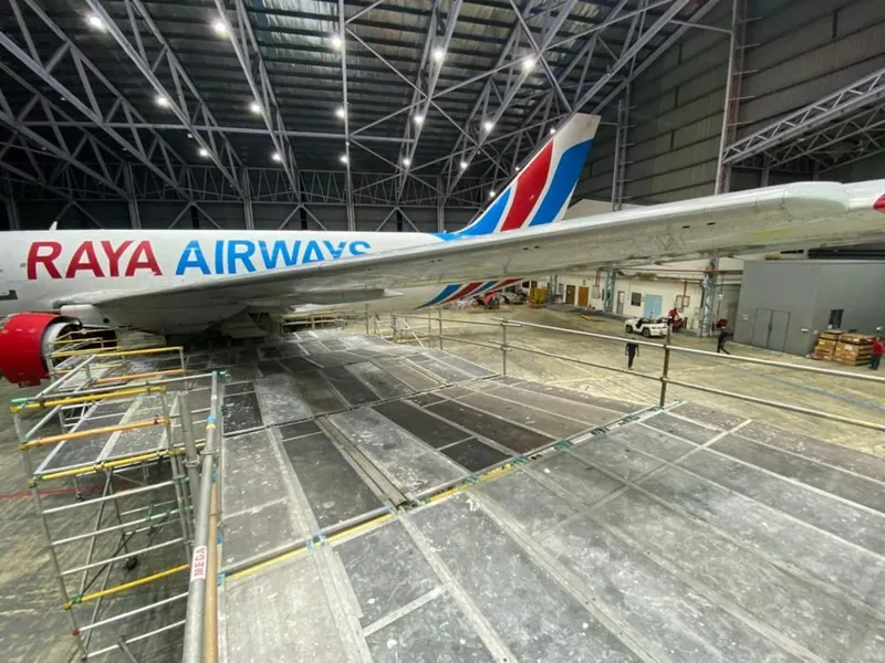 Raya Airways livery beside a working deck