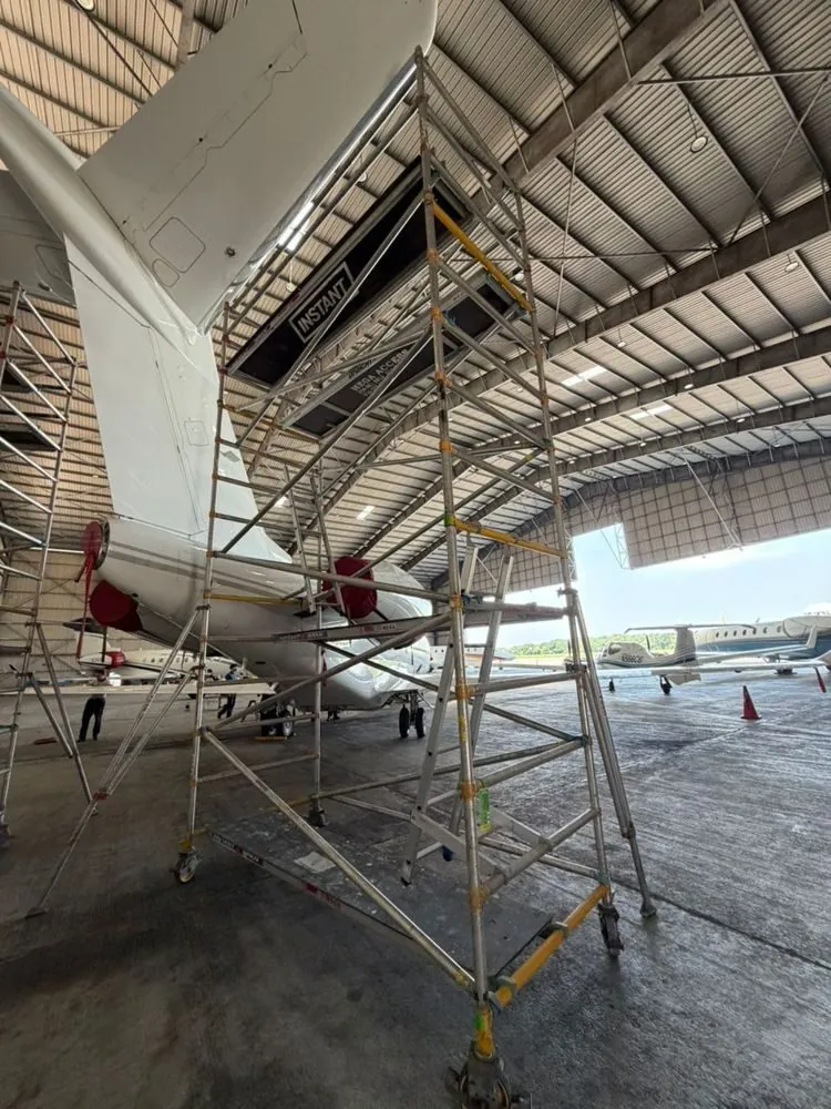 Tower reaching an aircraft tail section