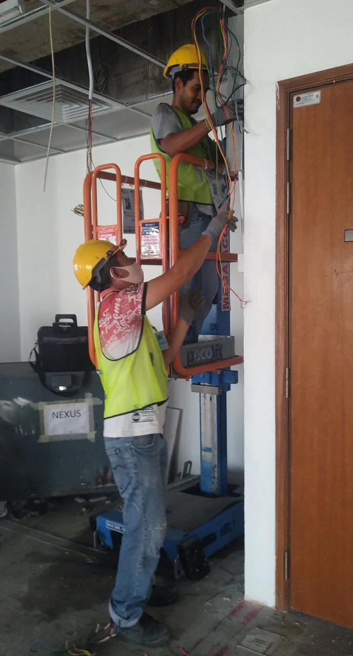 Pecolift beside a doorway during ceiling work