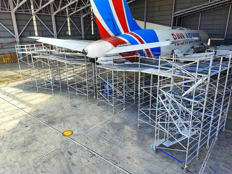 Mega platforms along a Raya Airways aircraft in the hangar