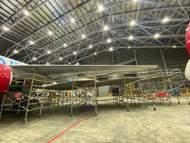 Raya Airways aircraft in its hangar with docking platforms